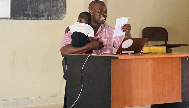 Un professeur porte le bébé de son étudiante